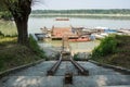 Traditional fishing boats tied up on the floating dock in picturesque surrounding of the big river Royalty Free Stock Photo