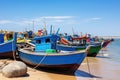 A traditional fishing village with colorful boats lined up along the shore