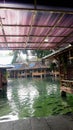 traditional floating restaurants over a large fish pond