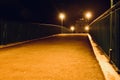 Traditional foot over bridge at night with lamp posts Royalty Free Stock Photo