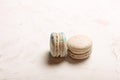 Traditional French almond caramel chocolate cranberry macarons dessert biscuits platter on white gray concrete textured background