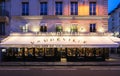 The traditional French brasserie Le Vaudeville at night. It is located near Brogniart palace in Paris, France