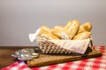 Traditional french bread in a wicker basket on a wooden table Royalty Free Stock Photo