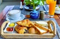 Traditional French breakfast - croissants, baguettes, toasted bread, jam and latte coffee, orange juice. Royalty Free Stock Photo