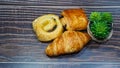 Traditional french butter croissant, Raisin Swirl and Chocolatine on wooden background Royalty Free Stock Photo