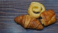 Traditional french butter croissant, Raisin Swirl and Chocolatine on wooden background Royalty Free Stock Photo