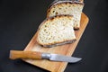 Traditional French country bread slices and pocket knife on a cutting board Royalty Free Stock Photo