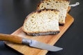 Traditional French country bread slices and pocket knife on a cutting board Royalty Free Stock Photo