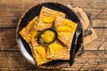 Traditional French crepe Suzette with orange sauce on a plate. Wooden background. Top view Royalty Free Stock Photo