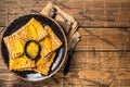 Traditional French crepe Suzette with orange sauce on a plate. Wooden background. Top view. Copy space Royalty Free Stock Photo