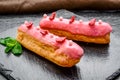 Traditional French dessert. Eclair with chocolate icing and raspberries. Royalty Free Stock Photo