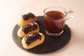 Traditional French dessert - eclairs with a cup of coffee