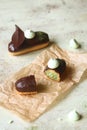 Traditional French Eclairs filled with Matcha Tea Pastry Cream and topped with chocolate glaze