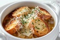 Traditional French onion soup in a white bowl, garnished with bread and cheese Royalty Free Stock Photo