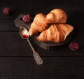 Puff pastry French croissants on a black background. Royalty Free Stock Photo
