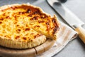 Traditional french pie. Quiche lorraine on kitchen table Royalty Free Stock Photo