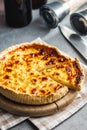 Traditional french pie. Quiche lorraine on kitchen table Royalty Free Stock Photo