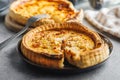 Traditional french pie. Quiche lorraine on kitchen table Royalty Free Stock Photo