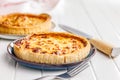 Traditional french pie. Quiche lorraine on white table Royalty Free Stock Photo