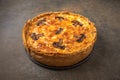 Traditional French pie quiche with mushrooms and cheese on a dark textured background Royalty Free Stock Photo