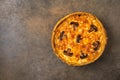 Traditional French pie quiche with mushrooms and cheese on a dark textured background Royalty Free Stock Photo