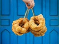 Hand holding traditional fresh baked donuts in Morocco