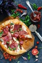 Traditional Fresh Italian pizza with dried salami tomatoes mozzarella cherry tomatoes and fresh green basil leaves. Royalty Free Stock Photo