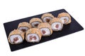 Traditional fresh japanese sushi on black stone Theca warm roll on a white background. Roll ingredients: tuna, philadelphia cheese Royalty Free Stock Photo