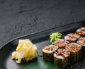 Traditional fresh japanese sushi futomaki on black plate Royalty Free Stock Photo