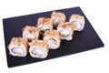 Traditional fresh japanese sushi rolls on a black stone Bonito abi on a white background. Roll ingredients: tiger shrimp, Royalty Free Stock Photo