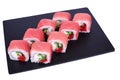 Traditional fresh japanese sushi rolls on a black stone Red Dragon on a white background. Roll ingredients: tuna, philadelphia Royalty Free Stock Photo