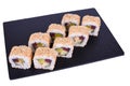 Traditional fresh japanese sushi rolls on a black stone Theca Spicy on a white background. Roll ingredients: tuna, daikon radish, Royalty Free Stock Photo