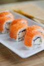 Traditional fresh Japanese sushi rolls with salmon on a white plate Royalty Free Stock Photo