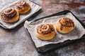 Traditional fresh sweet homemade cinnamon rolls with chocolate cream on a baking sheet. Scandinavian cuisine. Hyugge style