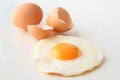 Traditional fried egg with cracked shell and whole egg Royalty Free Stock Photo