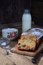 Traditional fruitcake with raisins, dried apricots, cherry for Christmas on wooden background. Sliced freshly baked cake and milk. Royalty Free Stock Photo