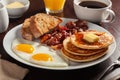 Traditional full american breakfast eggs pancakes with bacon and toast Royalty Free Stock Photo