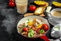 Traditional Full English Breakfast in cooking pan with fried eggs, bacon, mushrooms, chicken fillet, beans, toasts and fresh salad Royalty Free Stock Photo