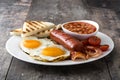 Traditional full English breakfast with fried eggs, sausages, beans, mushrooms, grilled tomatoes and bacon Royalty Free Stock Photo