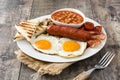 Traditional full English breakfast with fried eggs, sausages, beans, mushrooms, grilled tomatoes and bacon Royalty Free Stock Photo