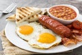 Traditional full English breakfast with fried eggs, sausages, beans, mushrooms, grilled tomatoes and bacon Royalty Free Stock Photo