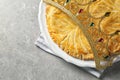 Traditional galette des Rois with decorative crown on light grey table, flat lay. Space for text