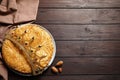 Traditional galette des rois with decorative crown on wooden table, flat lay. Space for text