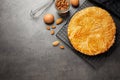 Traditional galette des rois and ingredients on grey table. Space for text