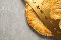 Traditional galette des Rois with paper crown on light grey table, flat lay. Space for text