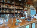 Traditional general store bar. Shelves with beverage bottles, cash register. Automobile Museum. Royalty Free Stock Photo