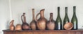 Traditional Georgian wine jugs, clay cups and bottles on a shelf Royalty Free Stock Photo