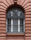 Wrought iron, black ornament window grid against brown wall Germany, Heidelberg city. Vertical