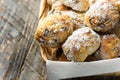 Traditional German Austrian Swiss Christmas pastry mini stollen cakes or cookies in wicker basket on plank wood table. Rustic
