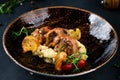 Traditional German braised beef cheeks in brown red wine sauce with spaetzle herbs Royalty Free Stock Photo